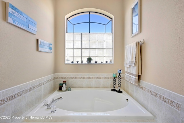 bathroom featuring tiled bath