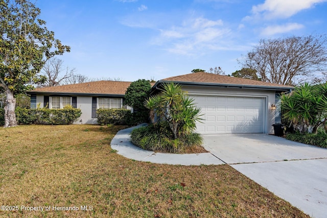 ranch-style home with a garage and a front yard