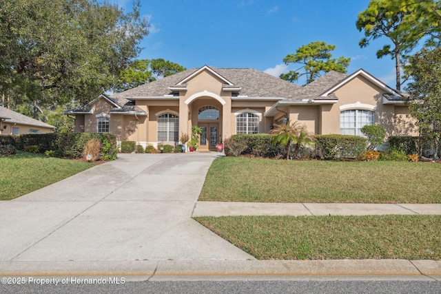 view of front of house with french doors and a front lawn