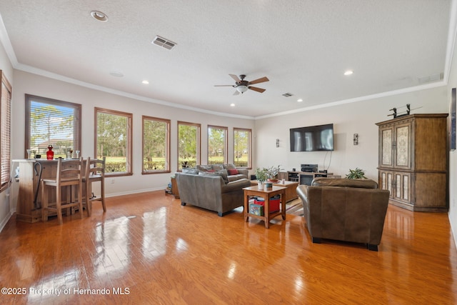 5351 Championship Cup Ln, Spring Hill, FL 34609 - living room with crown molding, wood-type flooring, and a textured ceiling