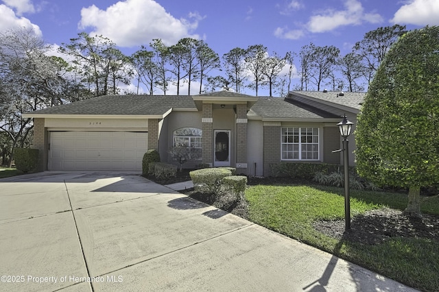 single story home featuring a garage and a front yard