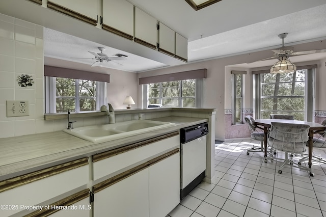 kitchen with sink, decorative light fixtures, dishwasher, a healthy amount of sunlight, and white cabinets