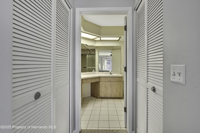 bathroom with tile patterned floors and vanity