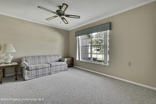 living room with ceiling fan, ornamental molding, and carpet