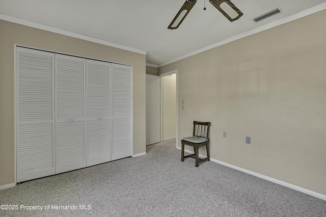 unfurnished bedroom featuring crown molding, ceiling fan, and a closet