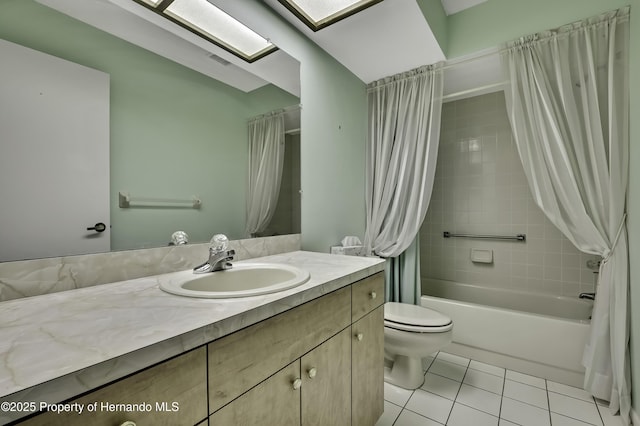 full bathroom with tile patterned flooring, vanity, shower / bath combo, and toilet