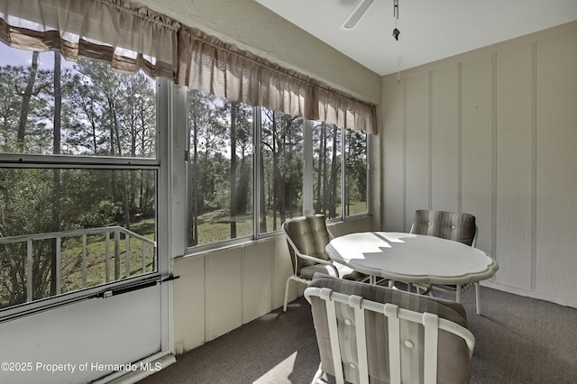 sunroom / solarium featuring ceiling fan