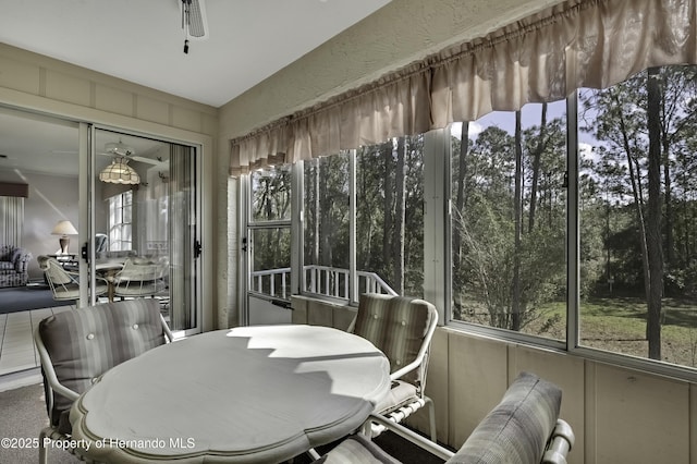 sunroom with ceiling fan and a healthy amount of sunlight