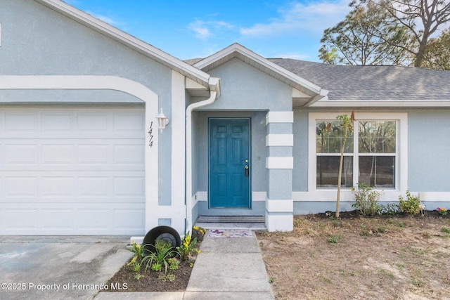 doorway to property with a garage