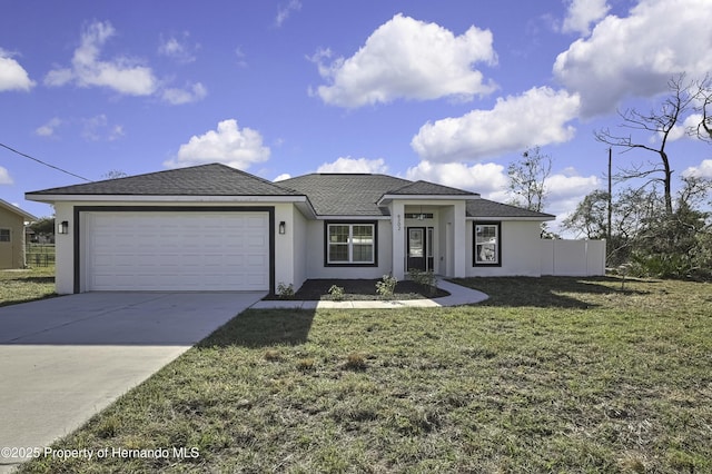 view of front of home featuring stucco siding, a front yard, fence, a garage, and driveway