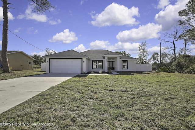 view of front of home with a garage, driveway, a front lawn, and stucco siding