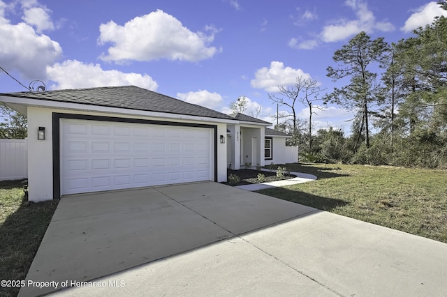 ranch-style house featuring a garage, a front yard, concrete driveway, and stucco siding