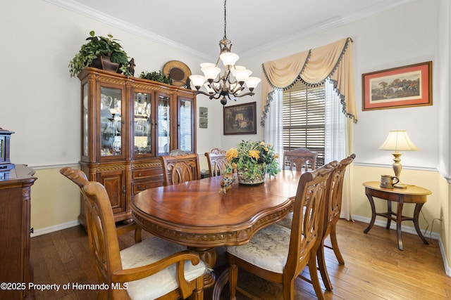 5685 W Pine Ridge Blvd, Beverly Hills, FL 34465 - dining space with light wood-type flooring, crown molding, and a notable chandelier