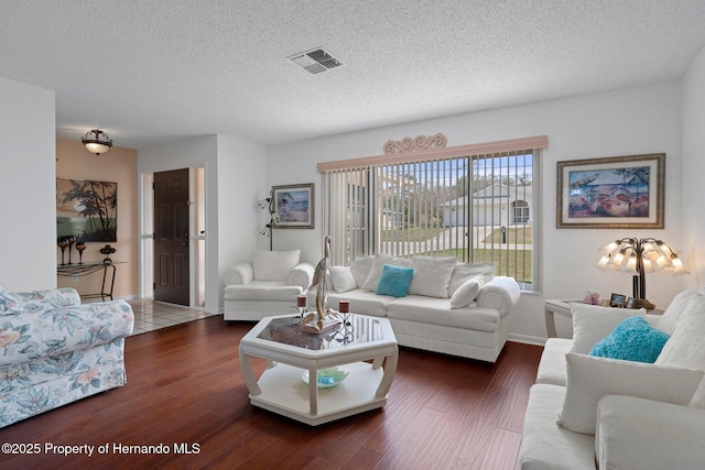 living room featuring dark hardwood / wood-style flooring and a textured ceiling