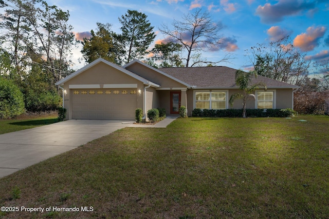 single story home featuring a garage and a yard