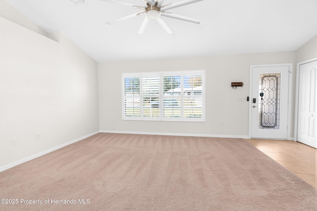 carpeted empty room featuring lofted ceiling and ceiling fan