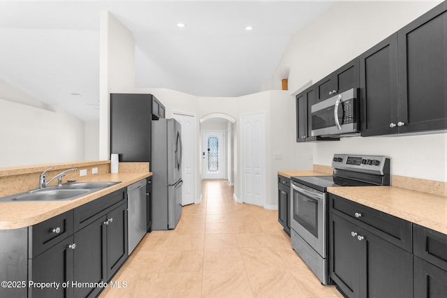 kitchen featuring appliances with stainless steel finishes, sink, and light tile patterned floors