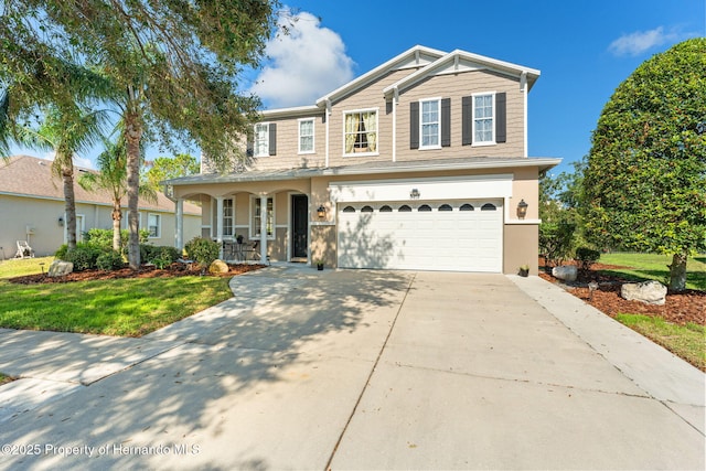 front of property featuring a garage, a front yard, and a porch