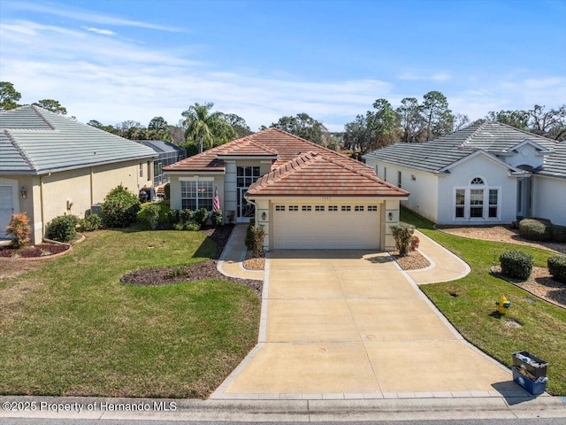 view of front of property with a garage and a front lawn