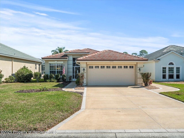 view of front of property featuring a garage and a front lawn