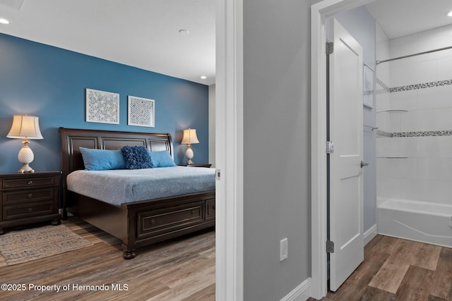 bedroom with wood finished floors and baseboards