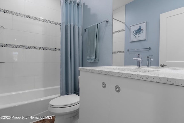 bathroom with vanity, toilet, and shower / bath combo with shower curtain