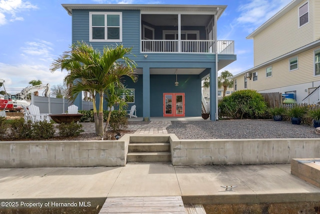 view of front of property with french doors, a patio area, and fence