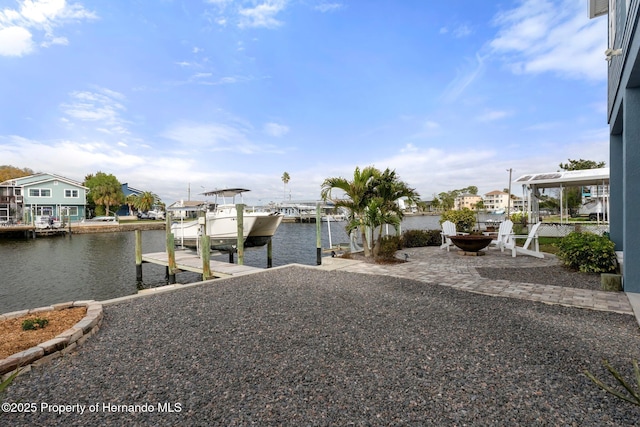 exterior space featuring a patio, a boat dock, a water view, and boat lift