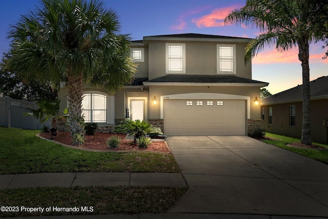 view of front of property featuring a yard and a garage