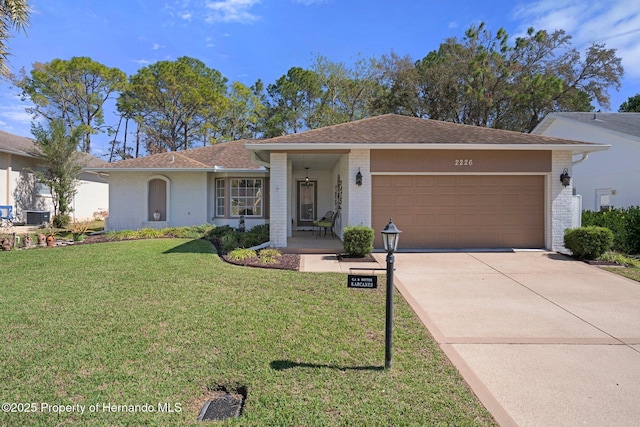 ranch-style house with a garage, a front lawn, and brick siding