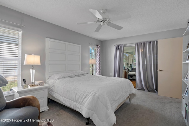 bedroom with carpet floors, access to outside, a ceiling fan, and a textured ceiling