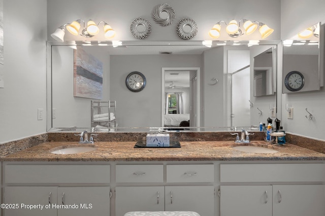 ensuite bathroom featuring double vanity, a sink, and ensuite bathroom