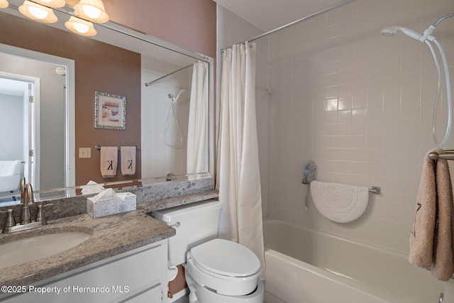 bathroom featuring toilet, shower / bath combo with shower curtain, and vanity