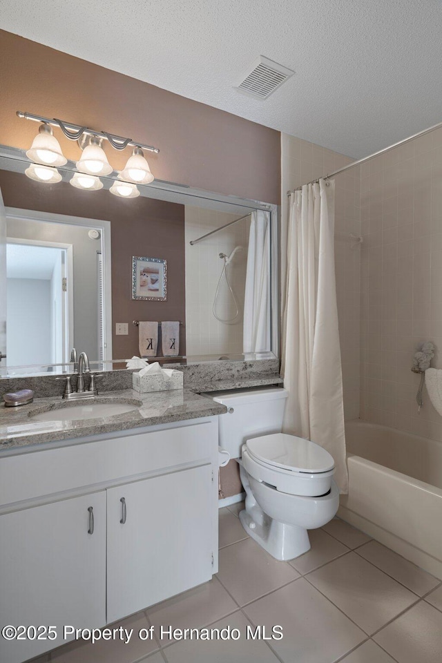 bathroom with visible vents, shower / bath combo with shower curtain, a textured ceiling, vanity, and tile patterned flooring