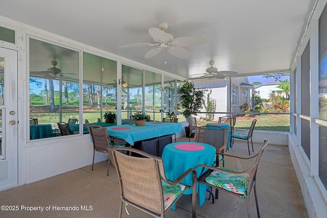 sunroom / solarium featuring a ceiling fan