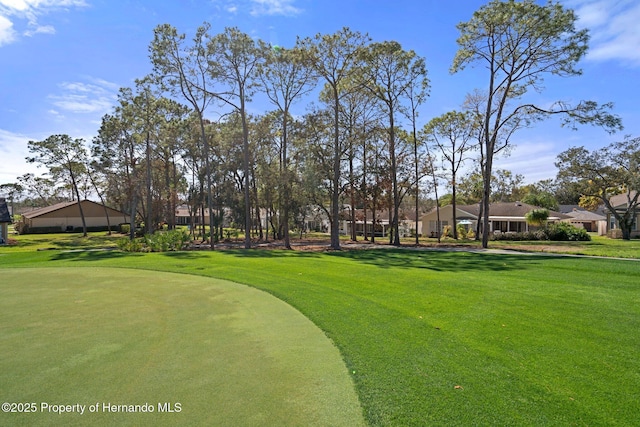 view of property's community with a yard and golf course view