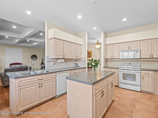 kitchen with sink, white appliances, backsplash, a center island, and light brown cabinetry