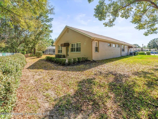 view of side of home featuring a lawn