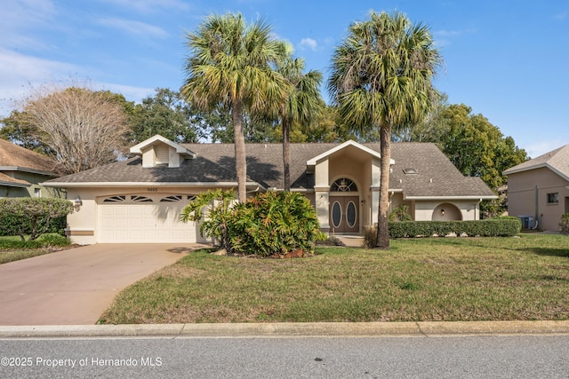 view of front of property featuring a garage and a front lawn