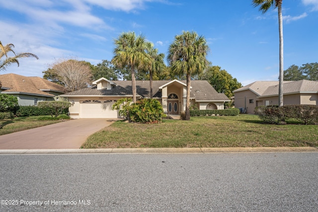 view of front of house featuring a garage and a front yard