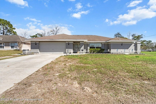 ranch-style house featuring a front lawn and a garage