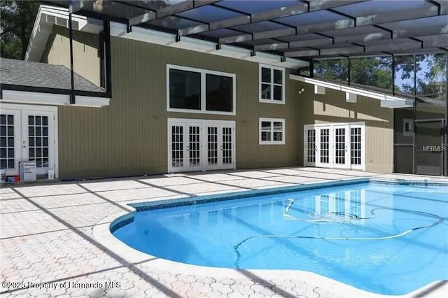 view of pool with a patio and french doors