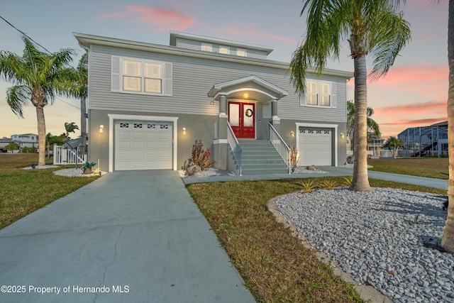 view of front facade with driveway, a garage, and stucco siding