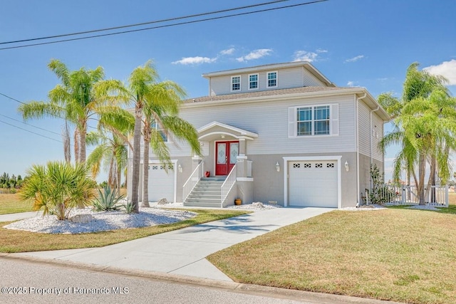 view of front of house with driveway, an attached garage, fence, and a front lawn