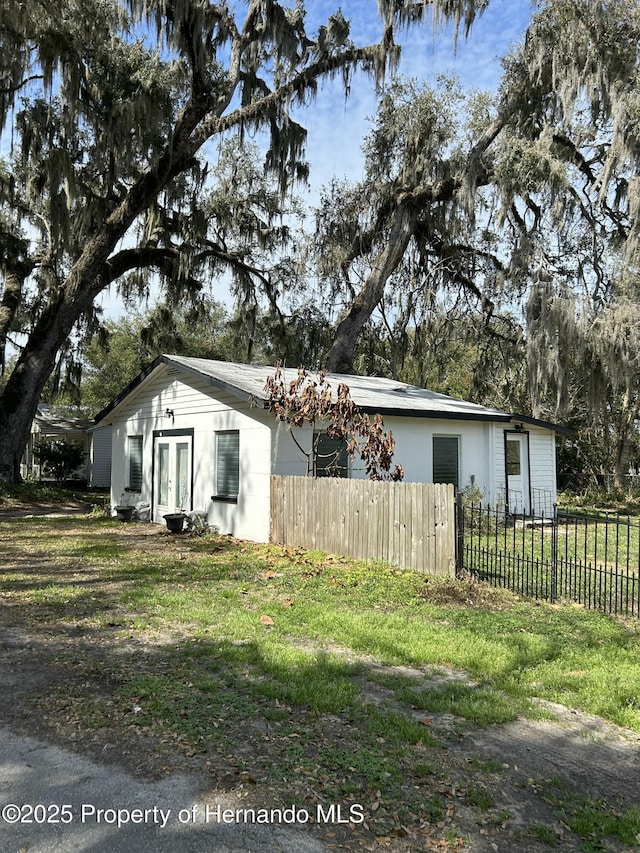 view of side of property featuring french doors