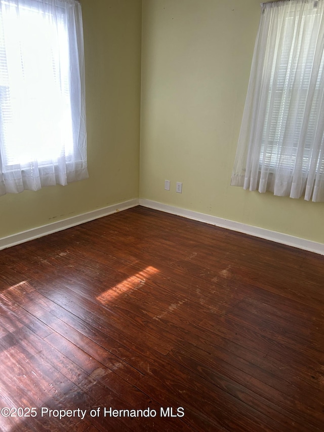 spare room with dark wood-type flooring