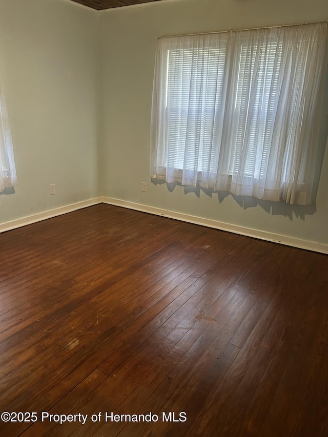 spare room with dark hardwood / wood-style floors