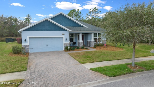 craftsman-style house with a garage, a porch, and a front lawn