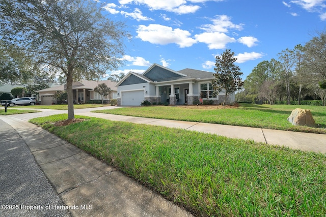 view of front of house featuring a garage and a front lawn