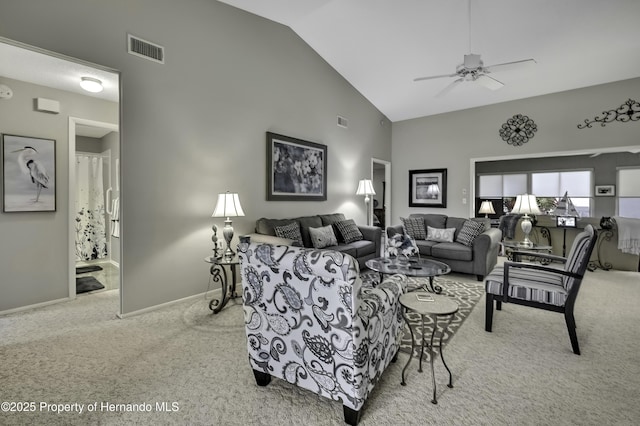 living area featuring baseboards, visible vents, light carpet, and high vaulted ceiling